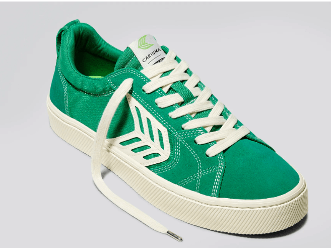 A single green shoe with white detailing from Brazilian brand Cariuma.