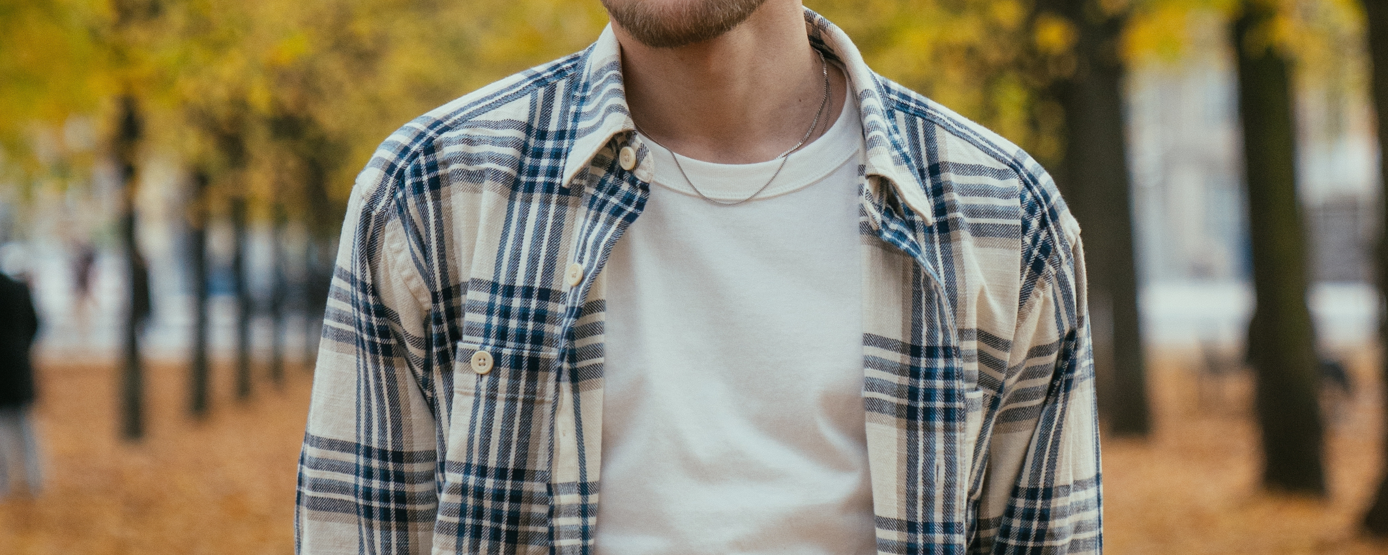 Closeup of a man wearing a t-shirt and flannel overshirt.