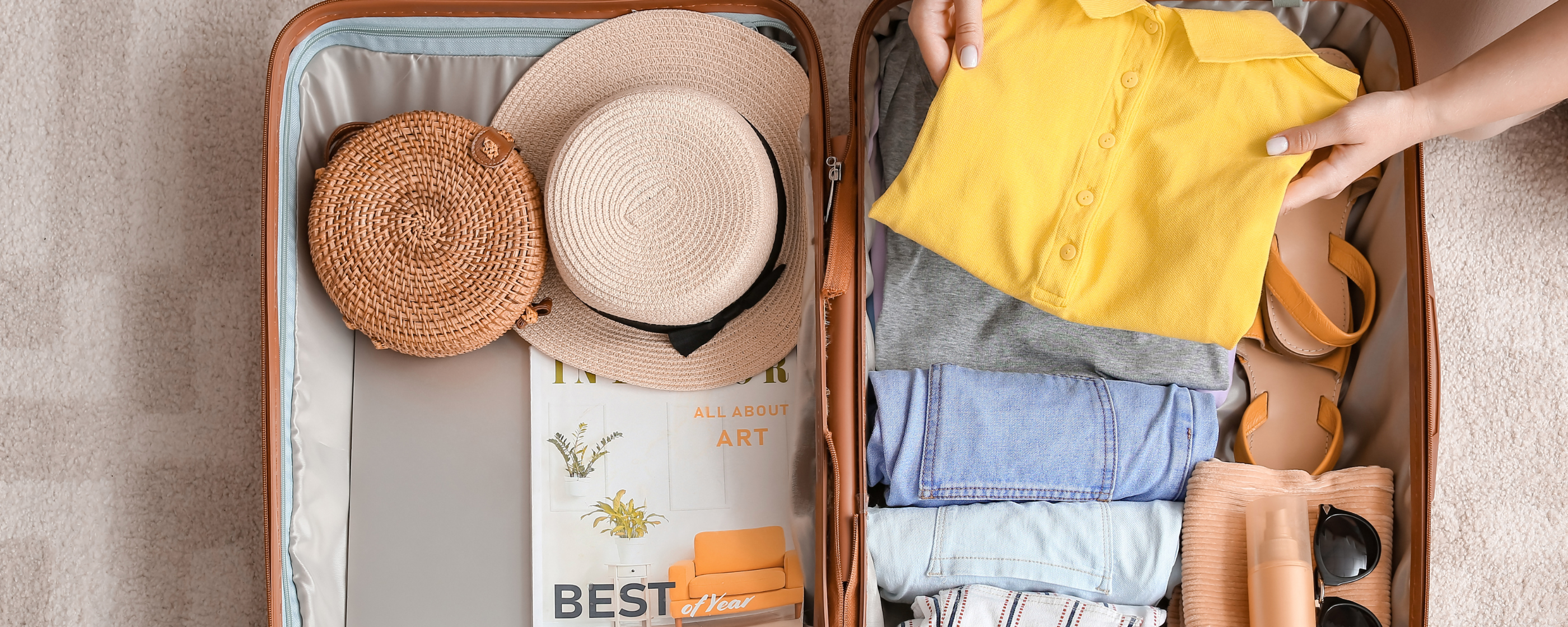 An open suitcase filled with clothing and other travel essentials.