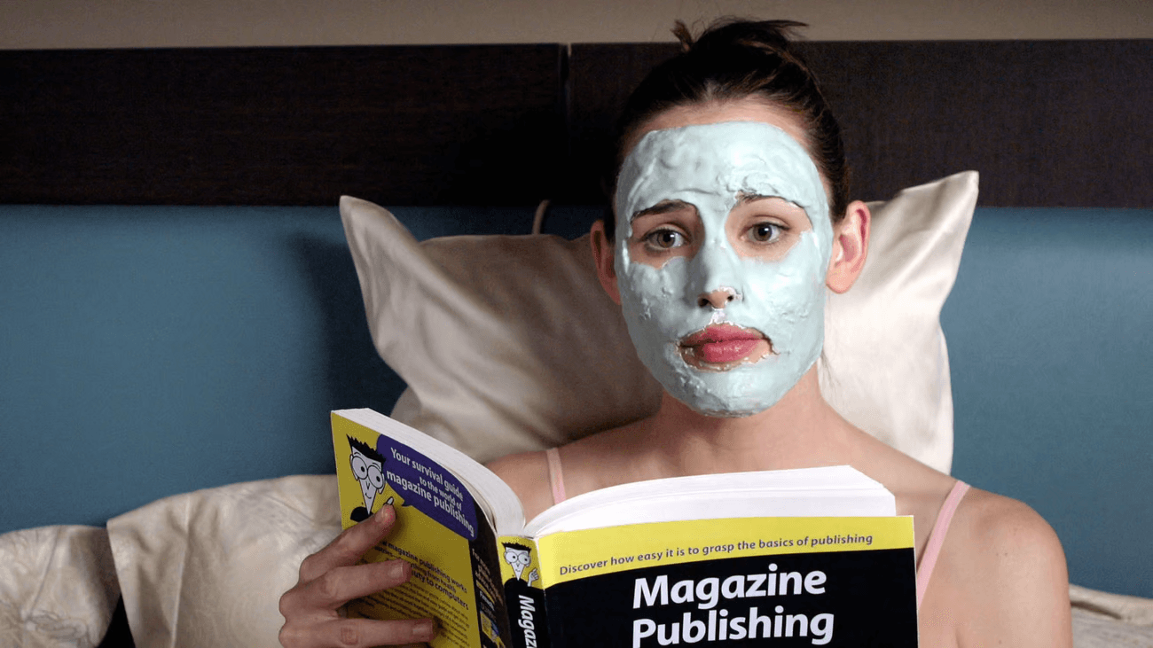 a woman in a green face mask reads in bed