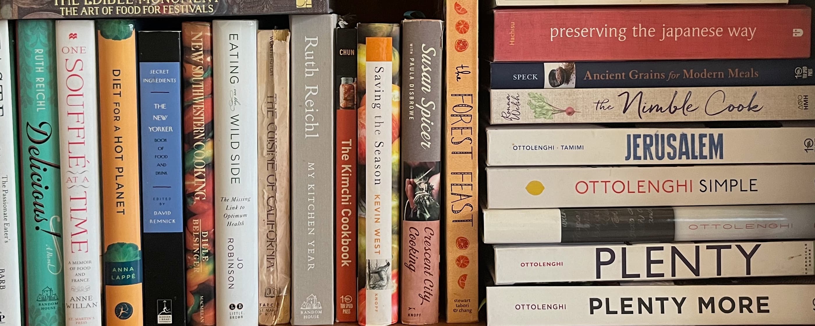 A selection of cookbooks on a shelf.