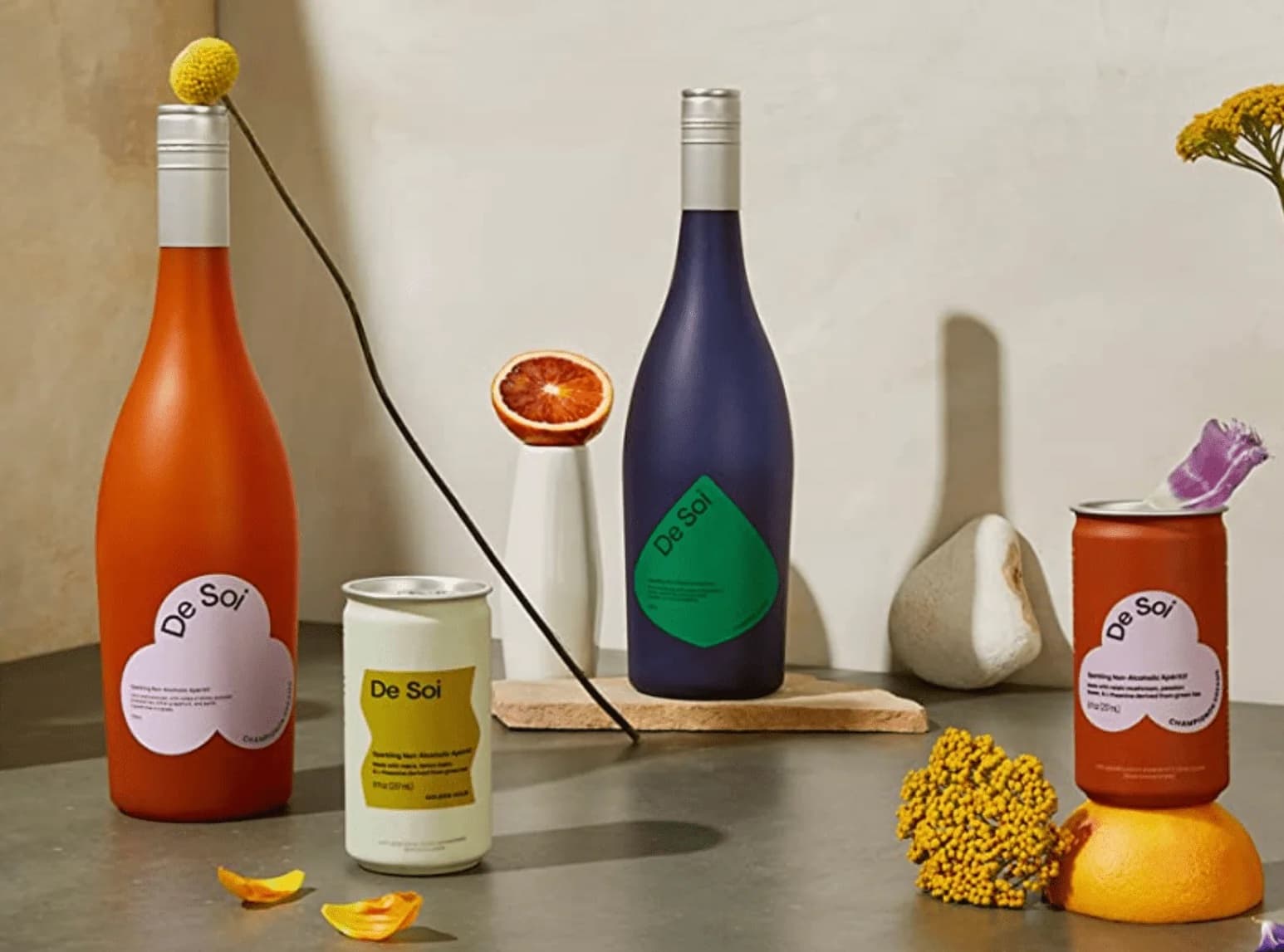 an assortment of attractive, colorful bottles and cans artfully arranged on a slate counter.