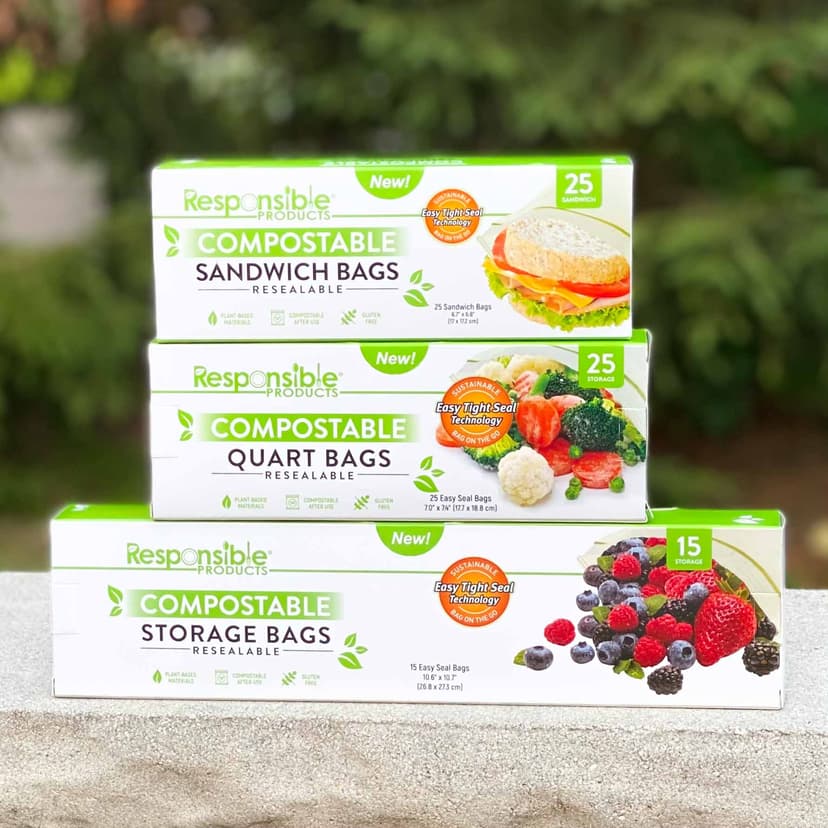 A stack of three white boxes with green and black writing and photos of food, showing that the bags contain Responsible Products brand Compostable Resealable Bags.