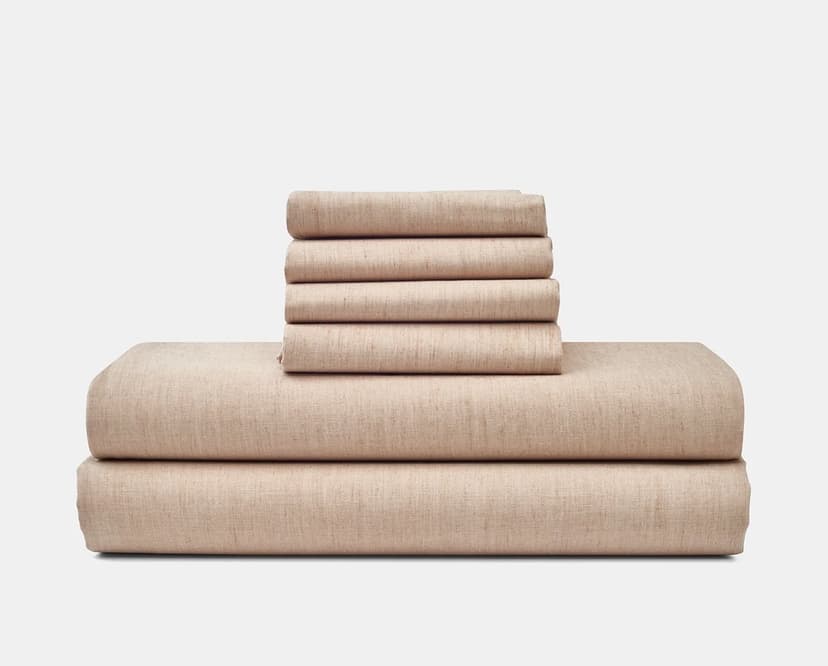 Folded sheets and pillowcases in a light brownish pink color.